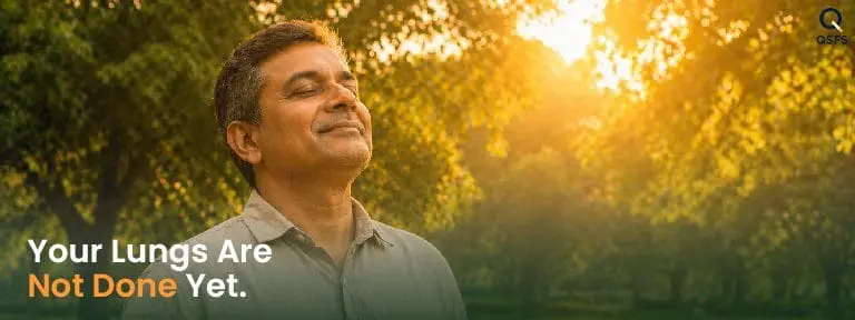 Indian man breathing deeply outdoors in morning light — representing lung recovery after quitting smoking